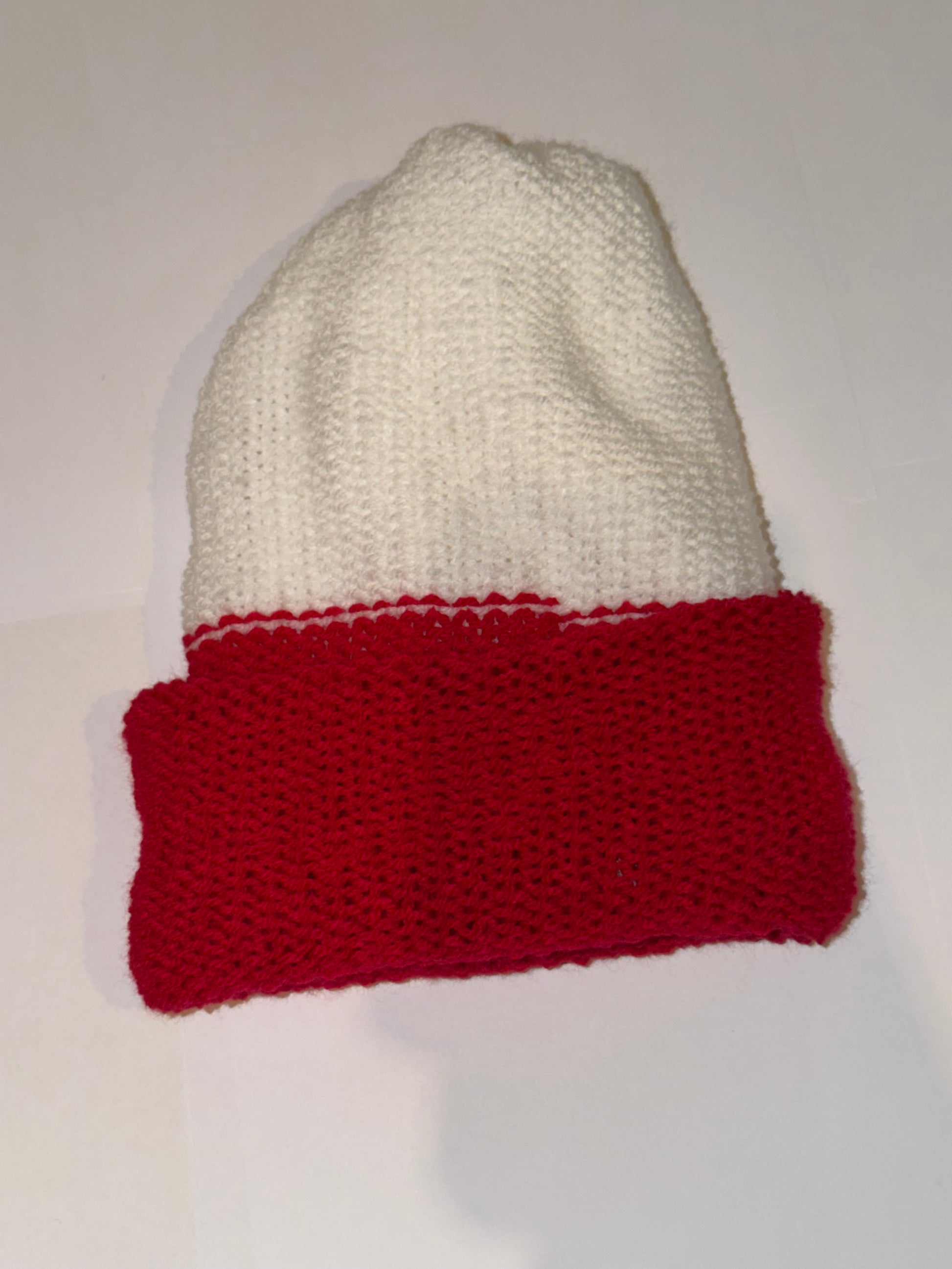 Festive Christmas Beanie in red and white colors, perfect handmade holiday accessory for winter warmth.