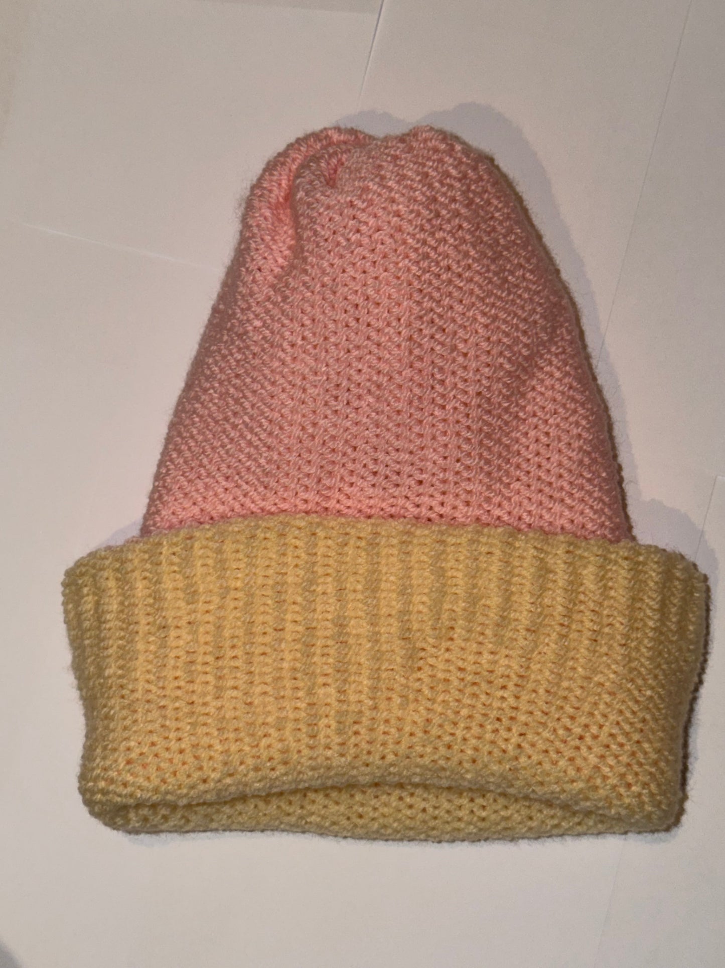 Handmade Reversible Wooly Beanie Light Pink and Cream displayed on a flat surface.