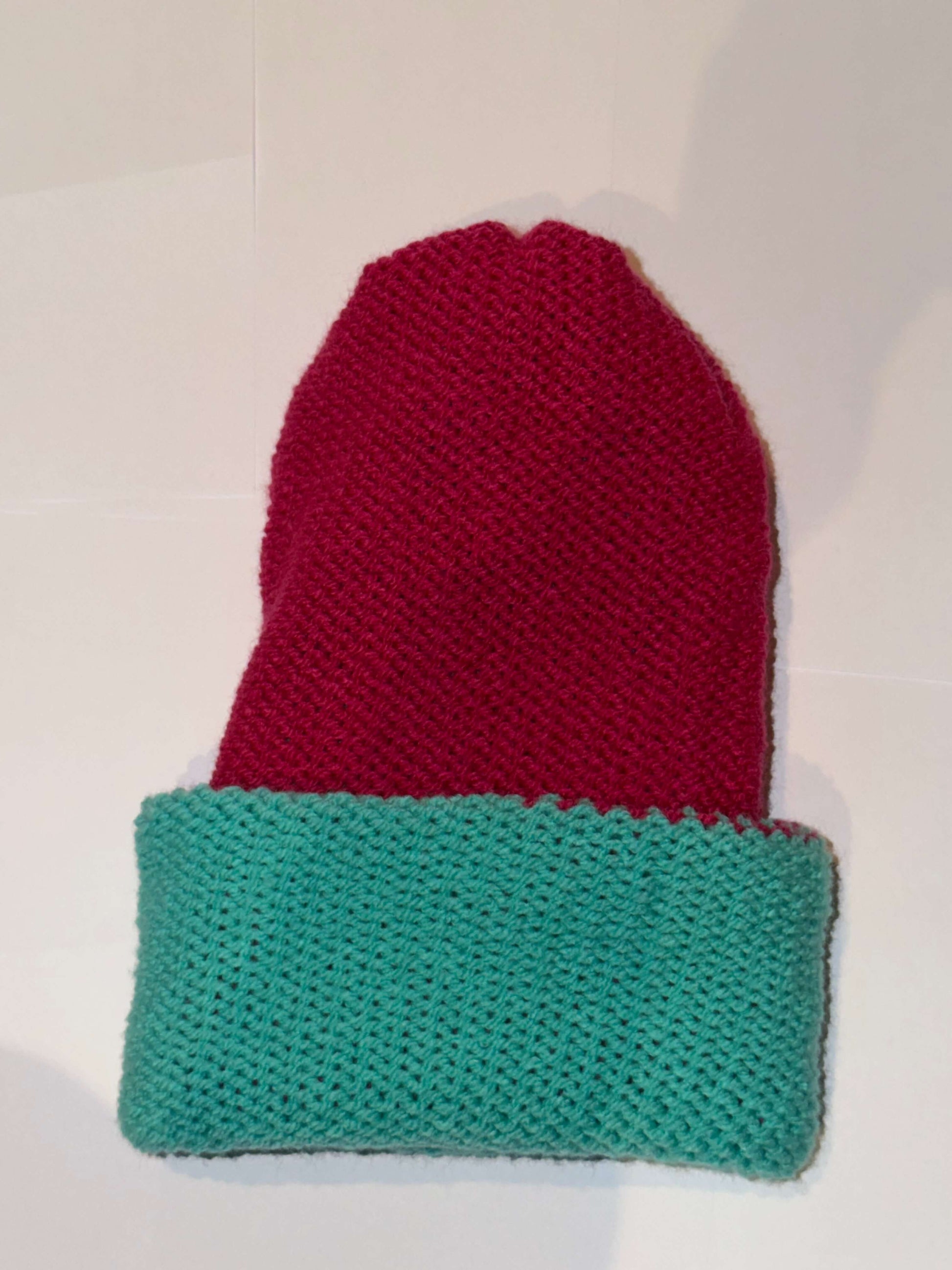 Handmade Reversible Wooly Beanie Aqua and Magenta showing the two-tone artisanal knit design.