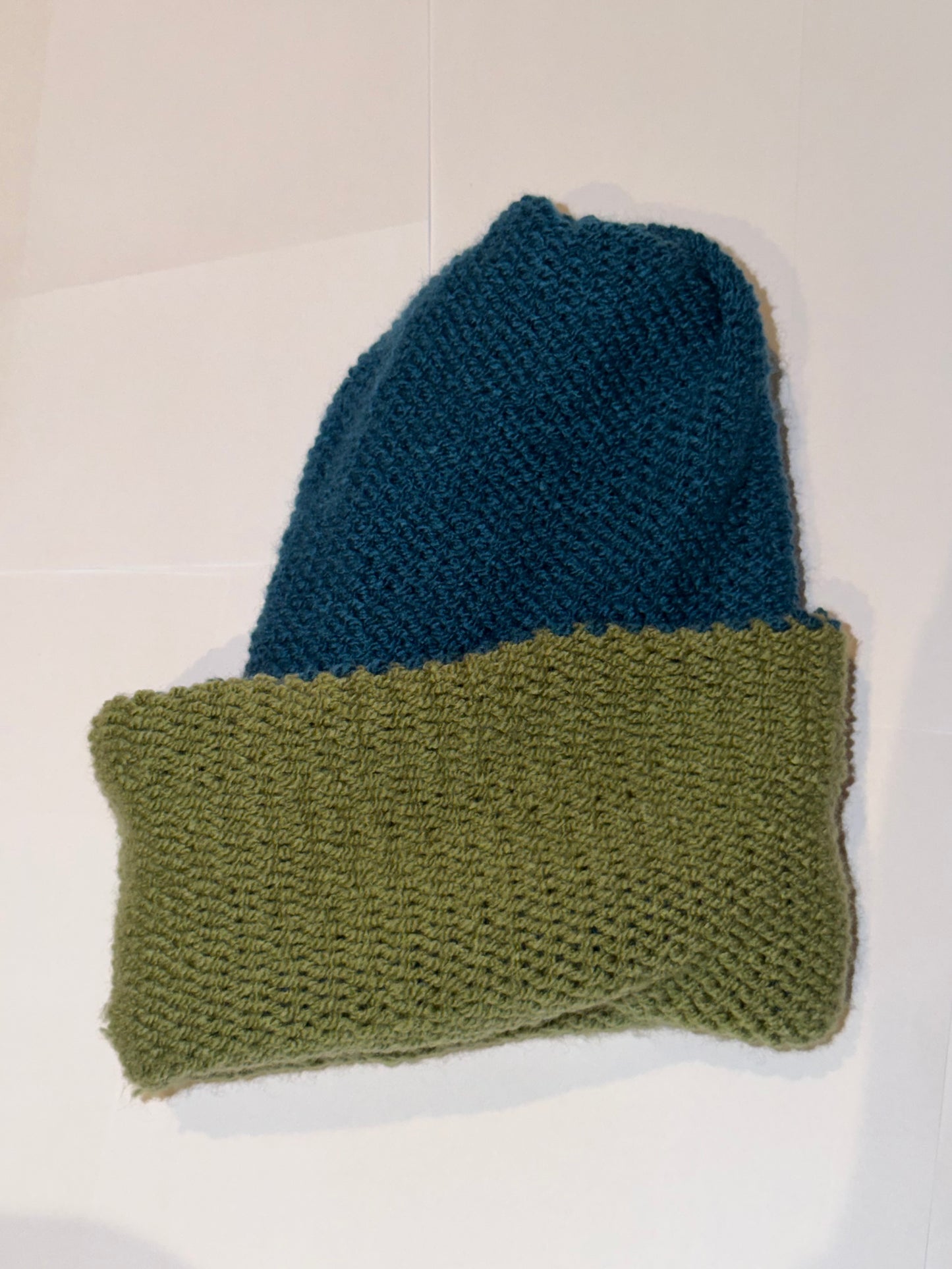 Handmade Reversible Wooly Beanie Petrol and Sage Green showing the earth-toned knit.